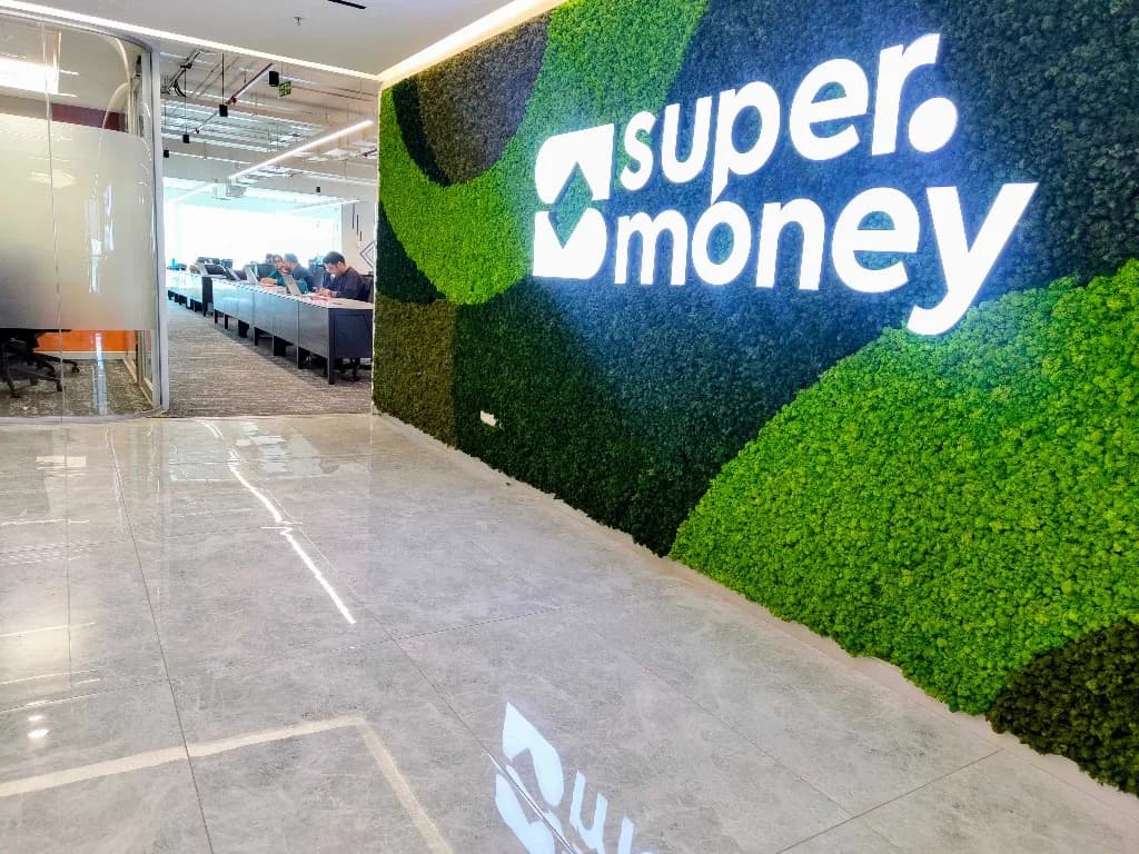 super.money logo on the office moss wall