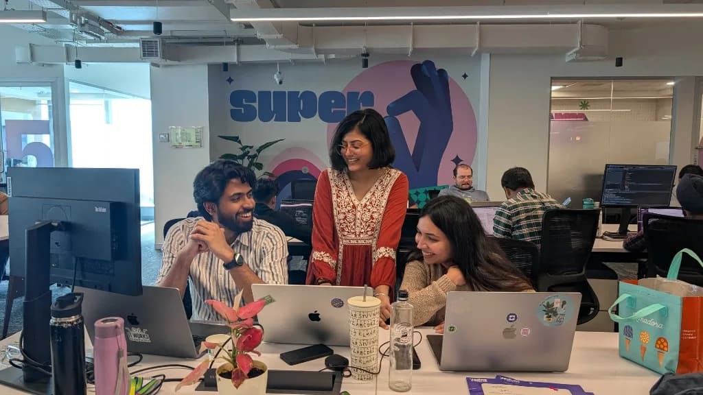 Colleagues collaborating at their desks
